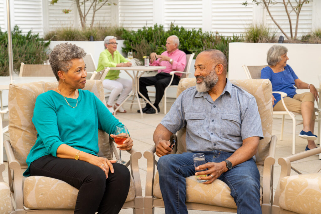 Senior couple lounges on the beautiful patio at The Pines at Davidson